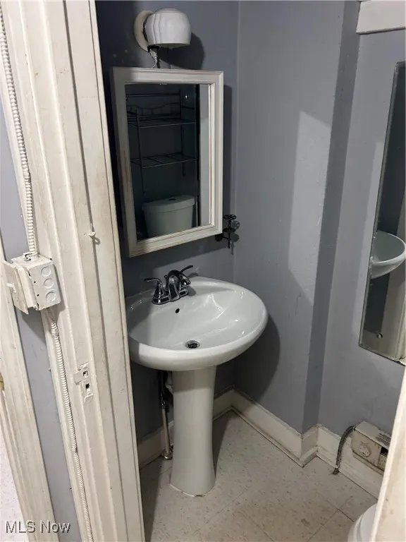 Bathroom with baseboards and toilet