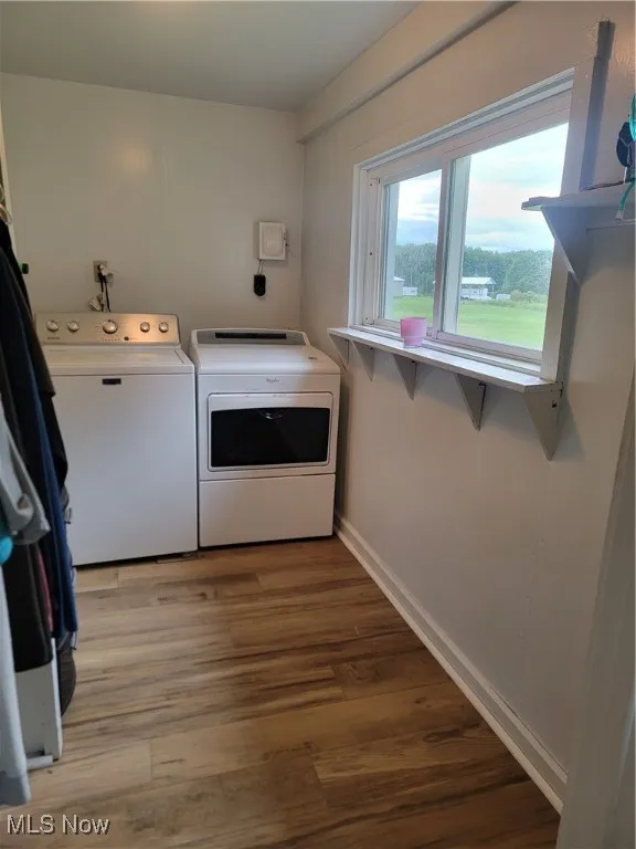 Washroom featuring light wood-type flooring and independent washer and dryer