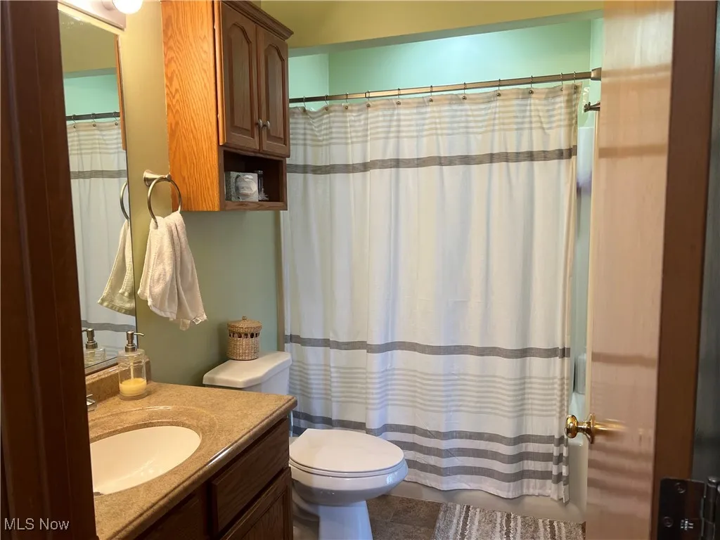 Main Bathroom with vanity and shower / bath combo with shower curtain
