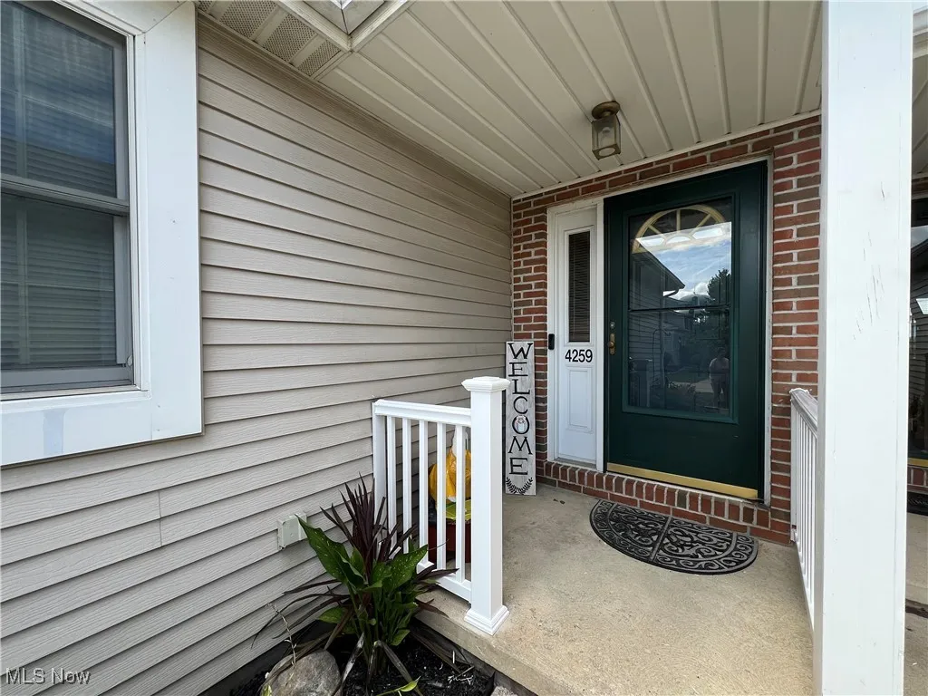 View of exterior entry with covered porch