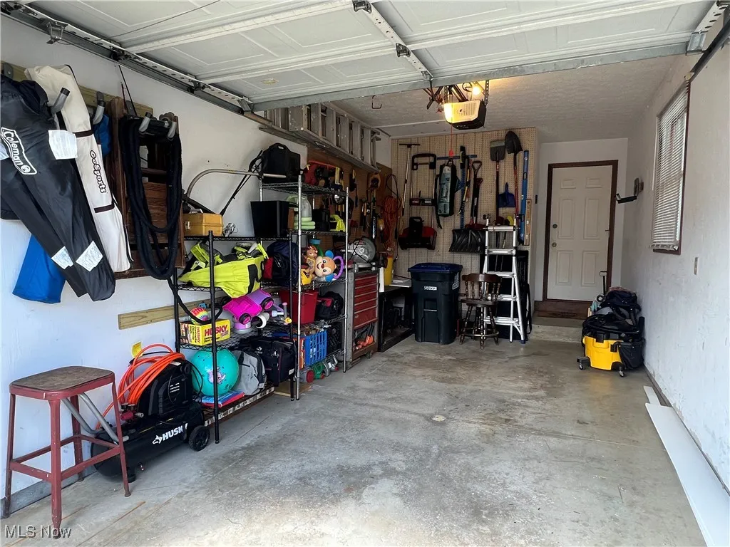 Garage with a garage door opener and water & easy access to home.