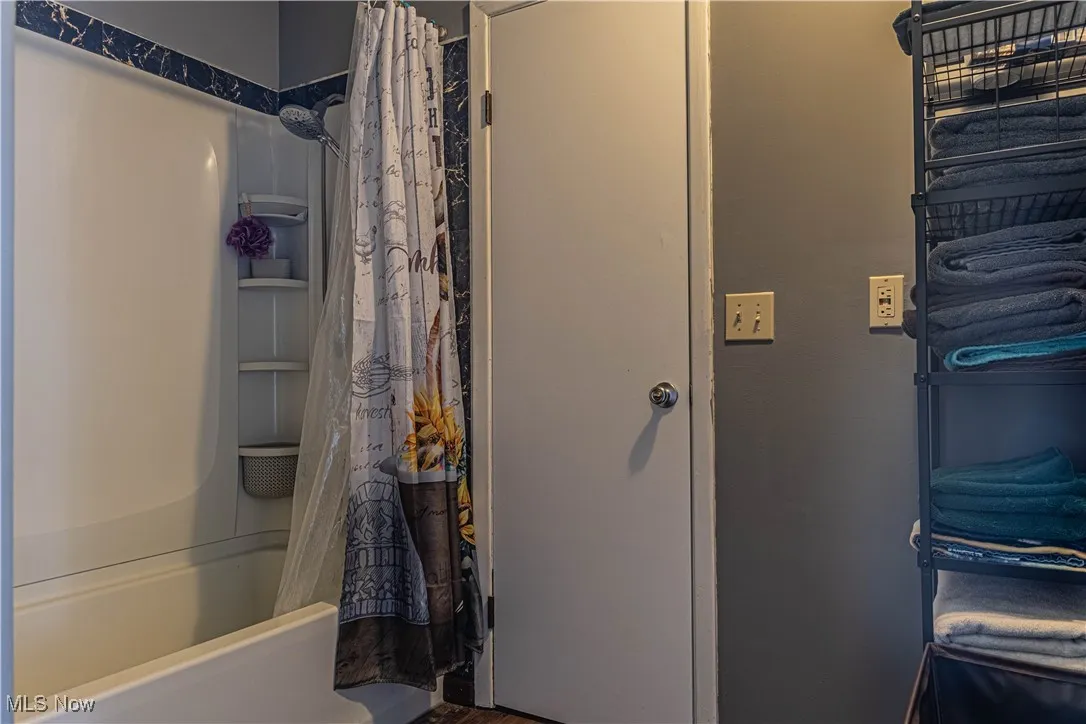Bathroom with shower / bathtub combination with curtain