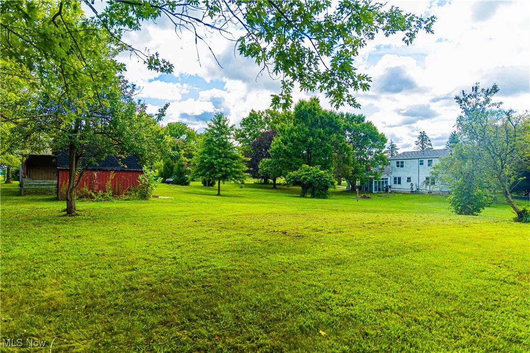 View of grassy yard with an outdoor structure