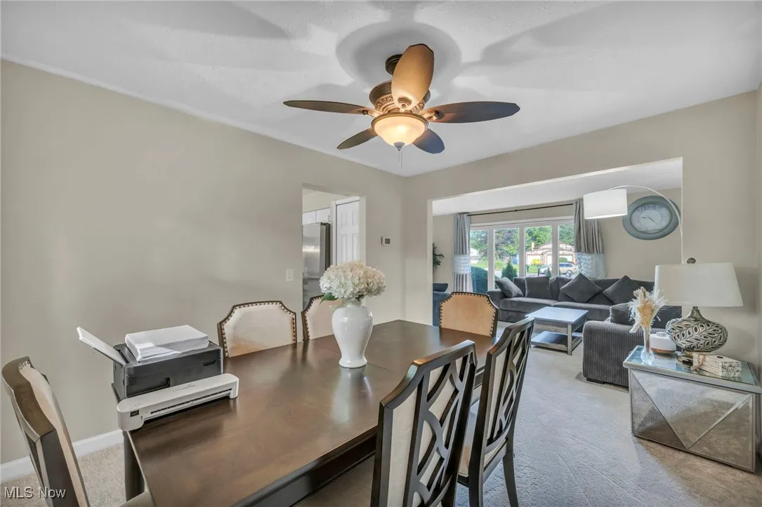 Dining area featuring carpet flooring and a ceiling fan