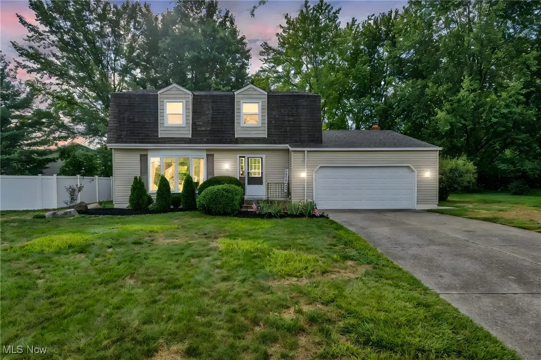 View of front of house with driveway and an attached garage
