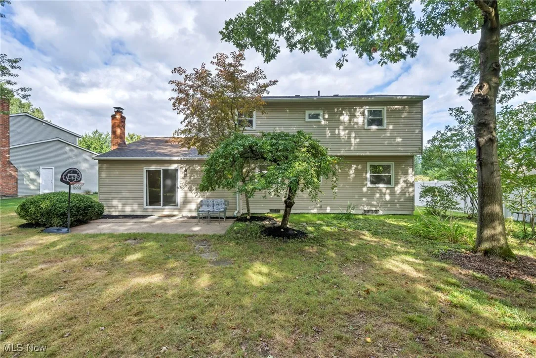 Back of house featuring a patio area and a lawn