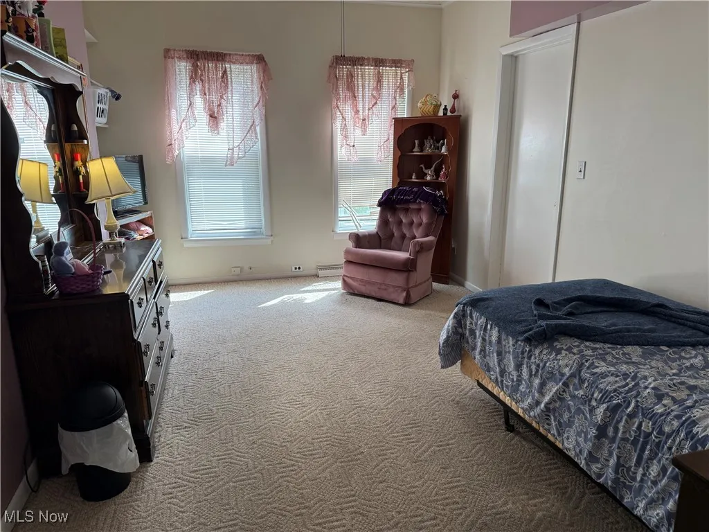 Carpeted bedroom with baseboards