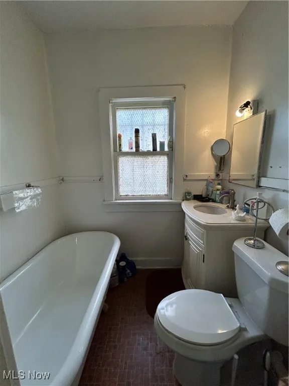 Full bath with a freestanding tub and vanity