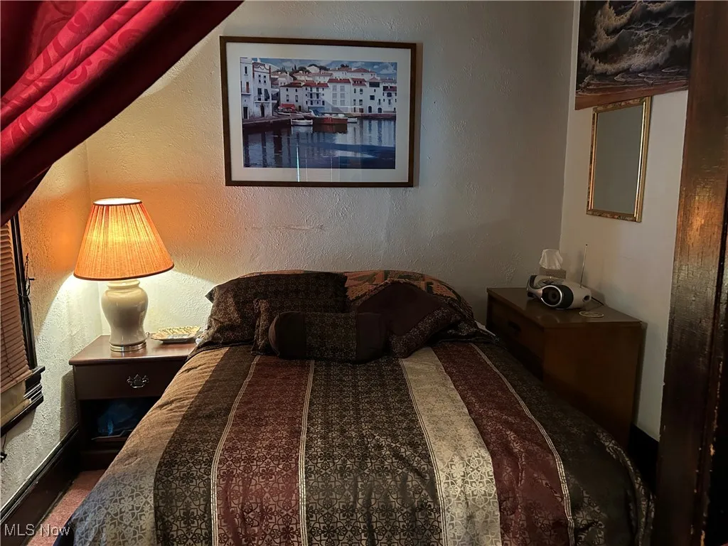 Bedroom featuring a textured wall