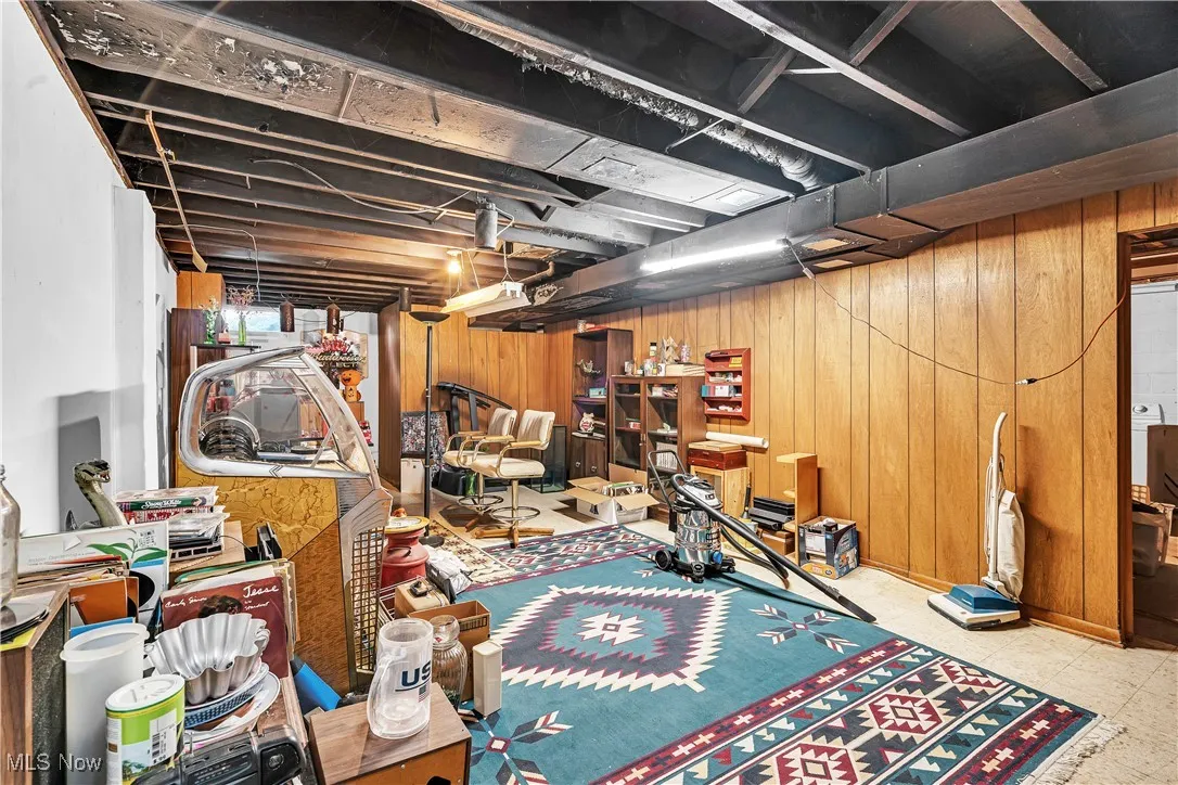 Basement featuring wooden walls