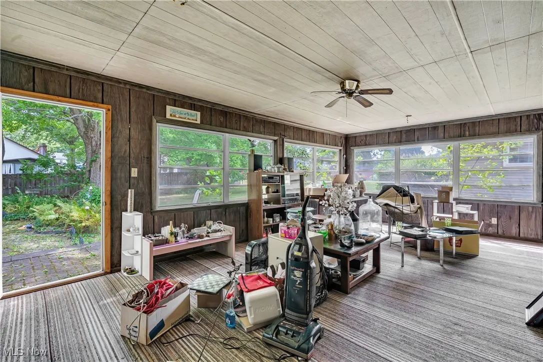 Sunroom / solarium with wooden walls, carpet floors, and wooden ceiling