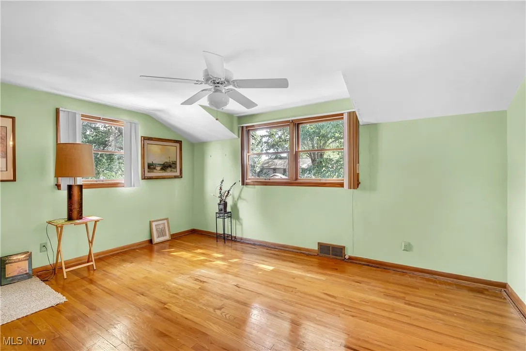 Additional living space featuring light wood-style floors and a ceiling fan