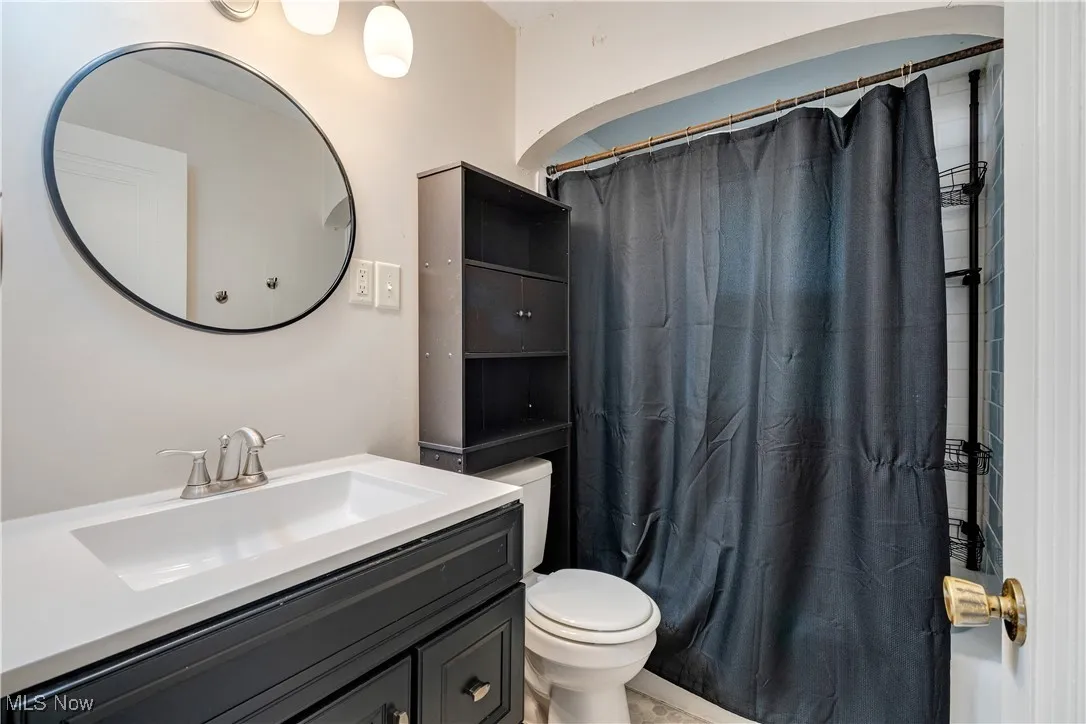 Full bathroom with vanity and toilet