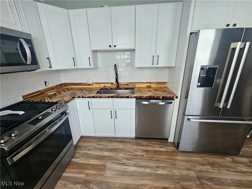 Upgraded kitchen featuring stainless appliances and new solid wood cabinets.