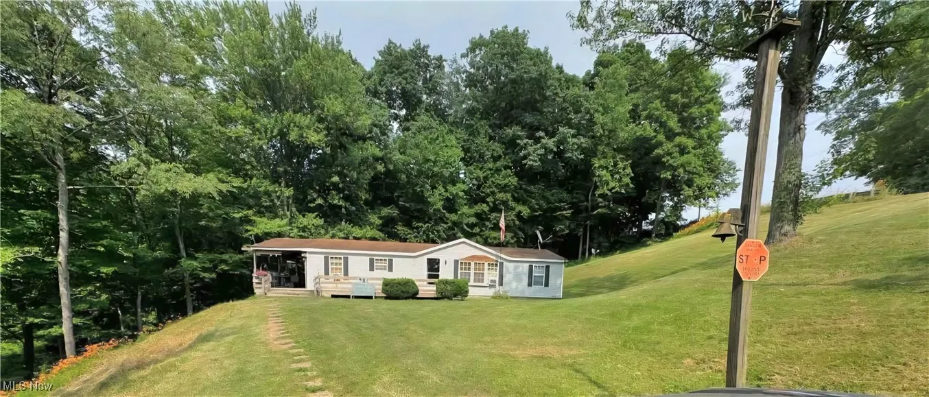 View of front of property with a front lawn and a sunroom