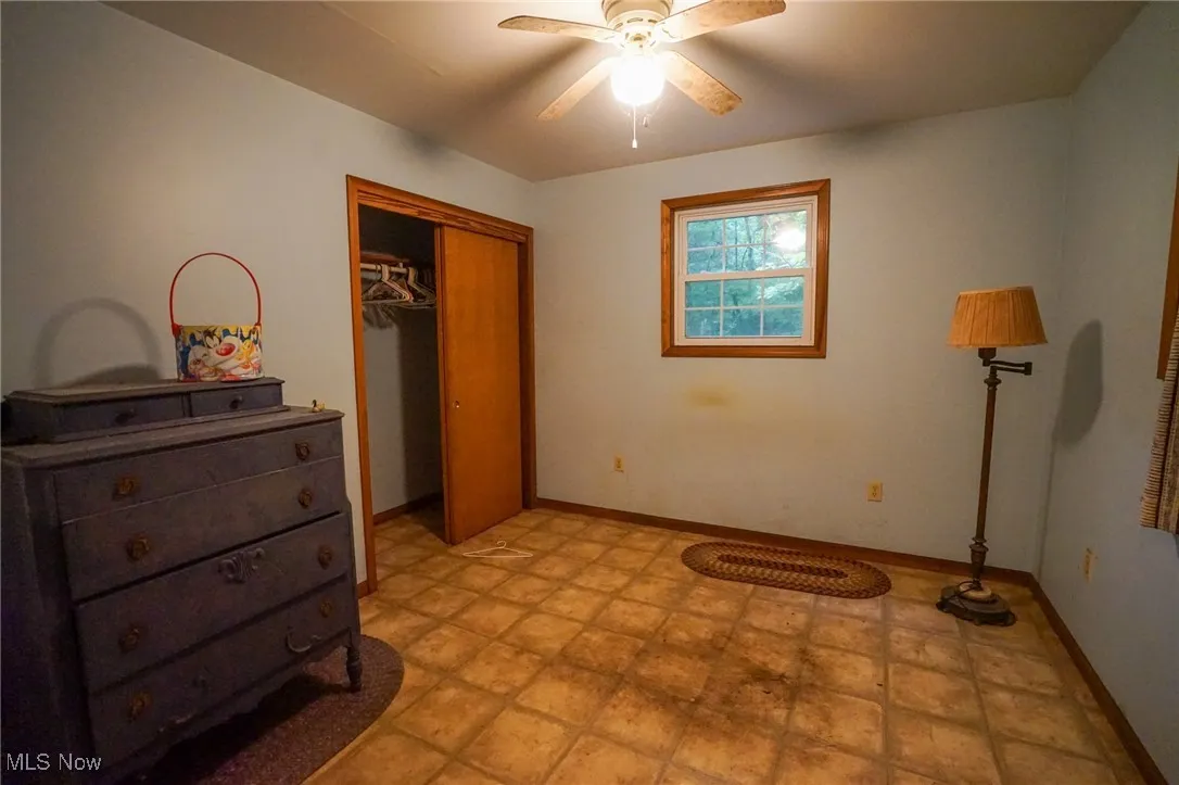 Bedroom featuring a closet and a ceiling fan
