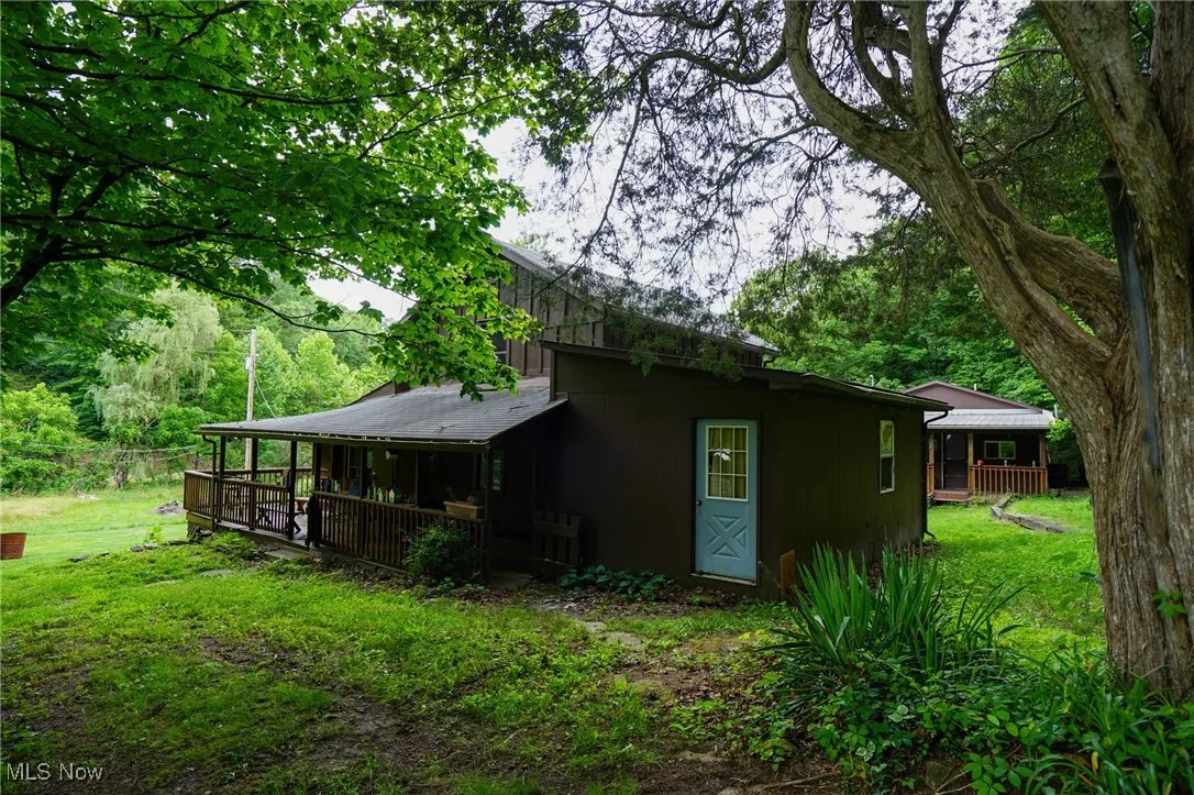 Rear view of property with a yard and a wooden deck