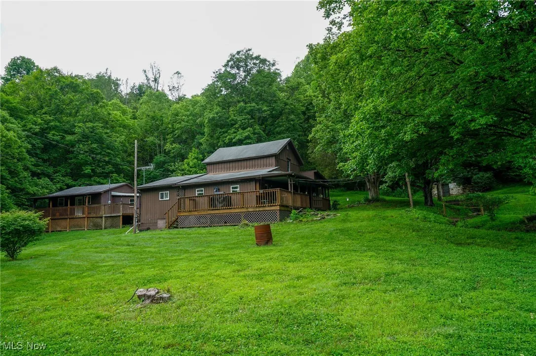 Back of property featuring a yard and a deck