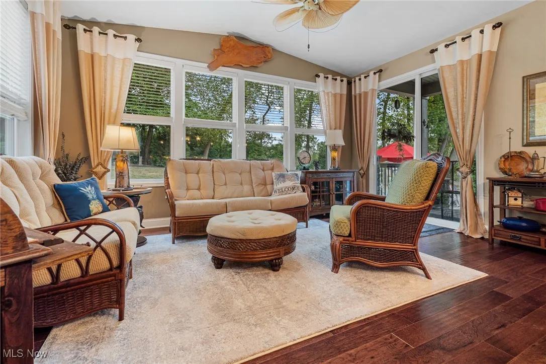 All season room surrounded by windows with sliding door that leads out to the covered patio and backyard.
