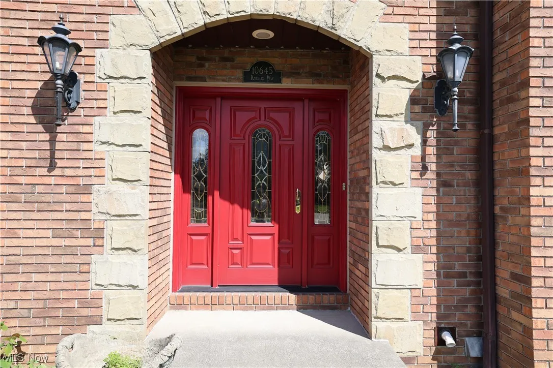 View of exterior entry with brick siding