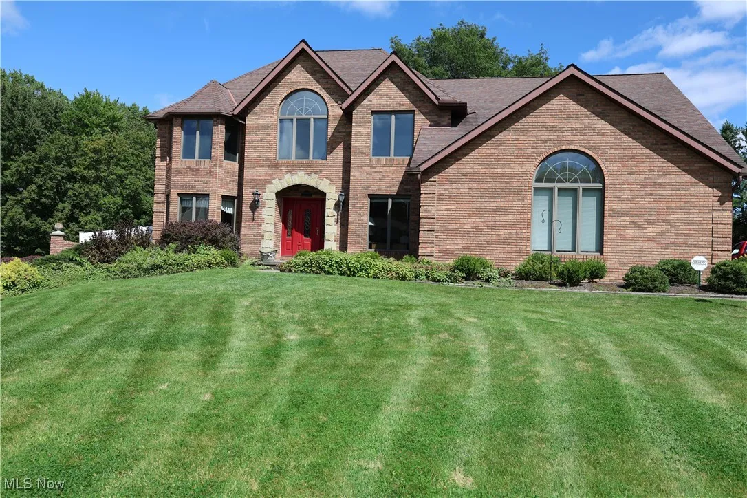 View of front of property with a front lawn and brick siding
