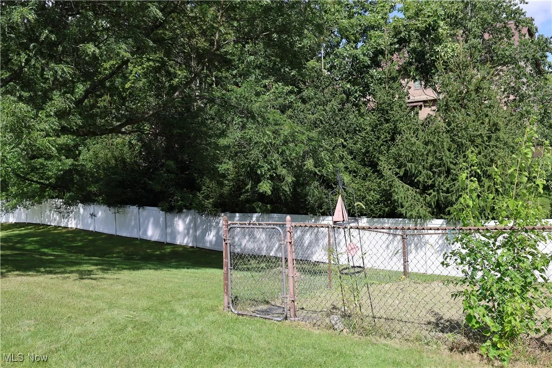 View of yard with fenced in garden area