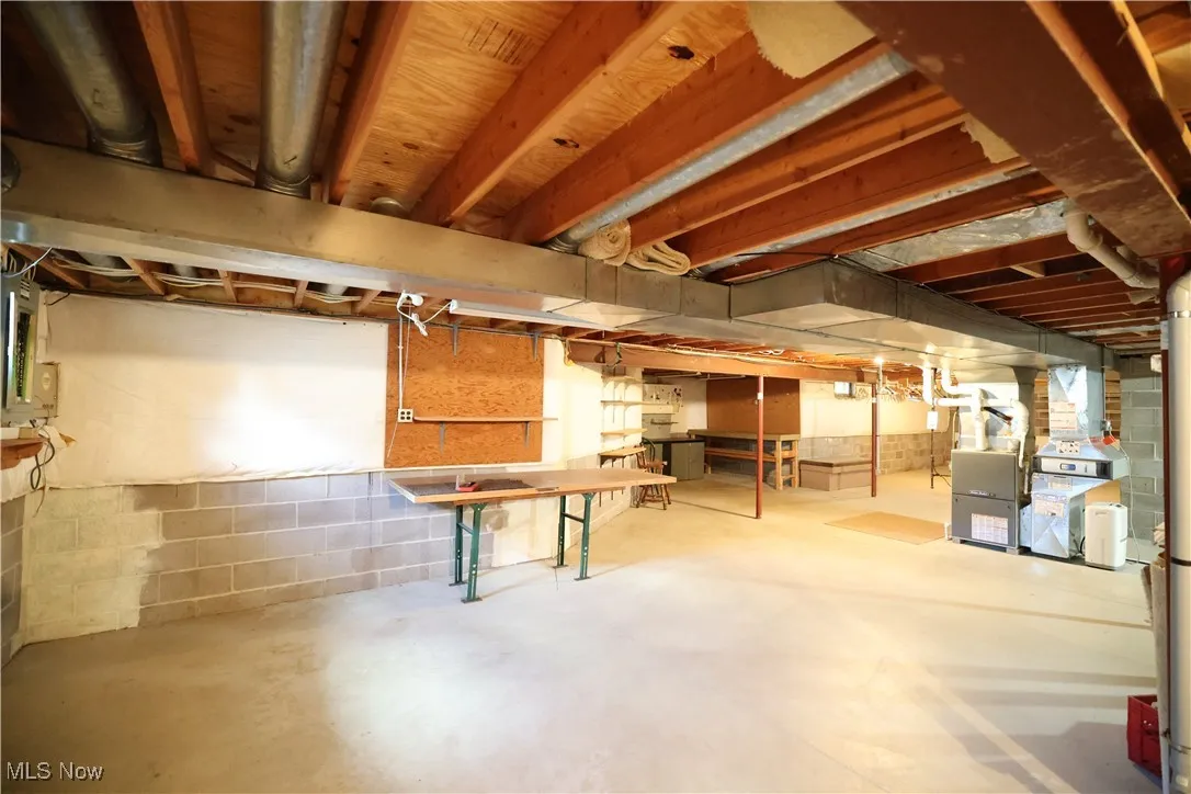 Unfinished basement featuring electric panel