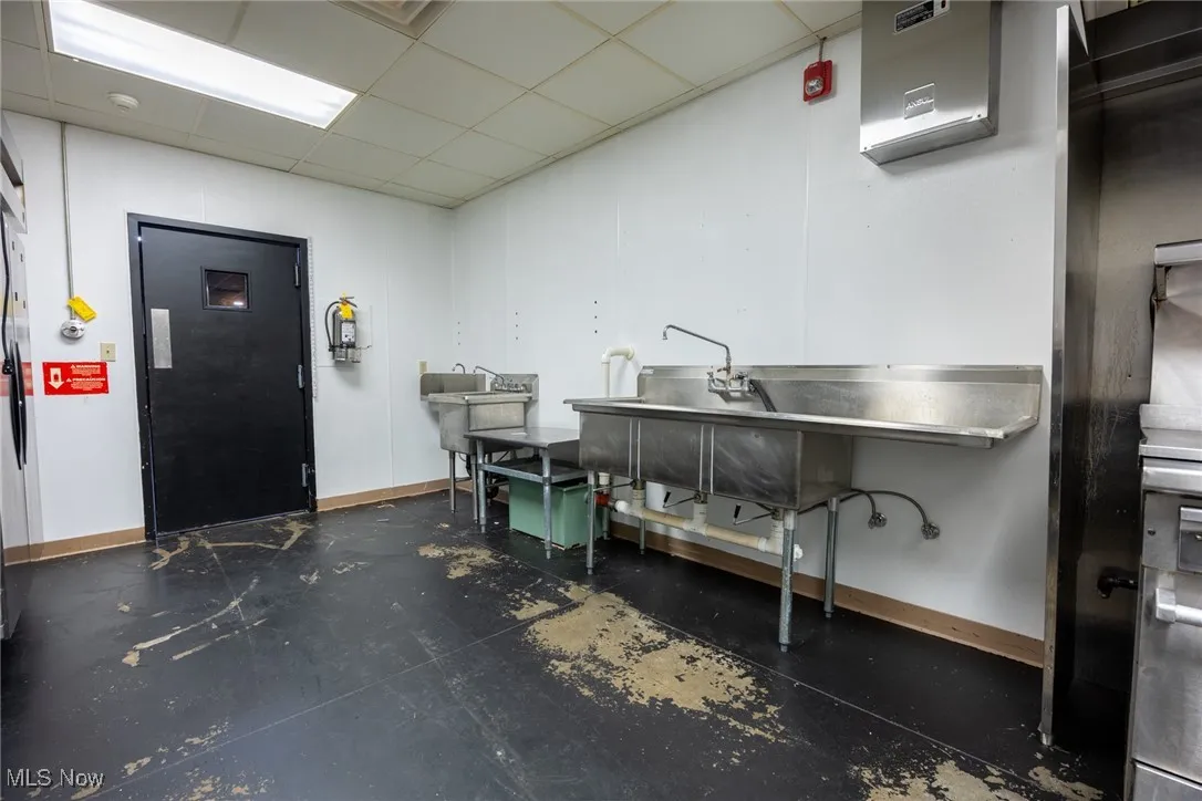 Misc room featuring concrete floors and a paneled ceiling