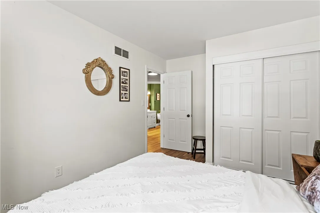 Bedroom with a closet and wood finished floors