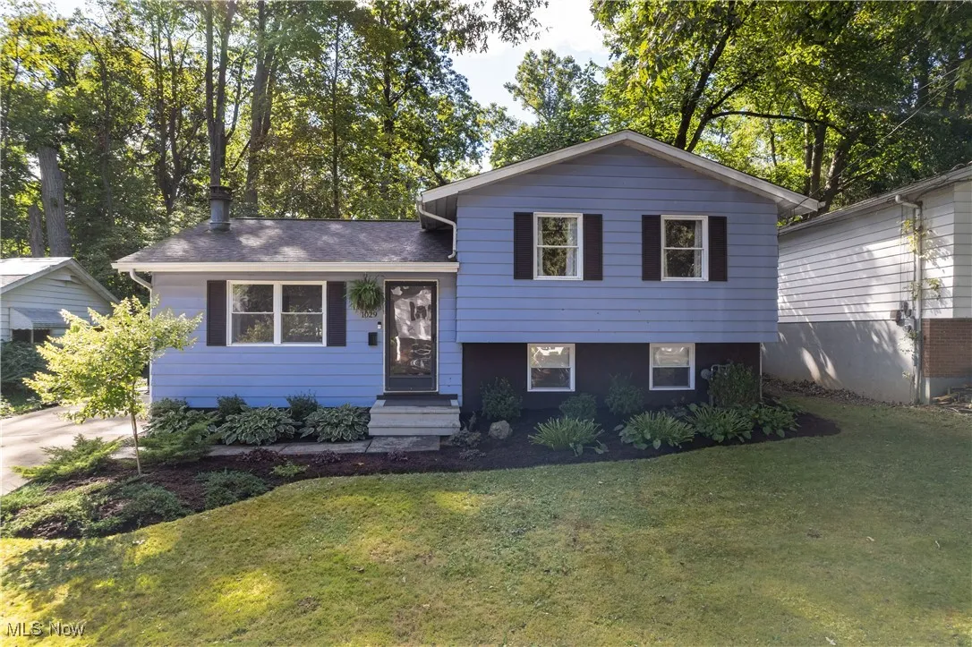 Split level home featuring a front yard