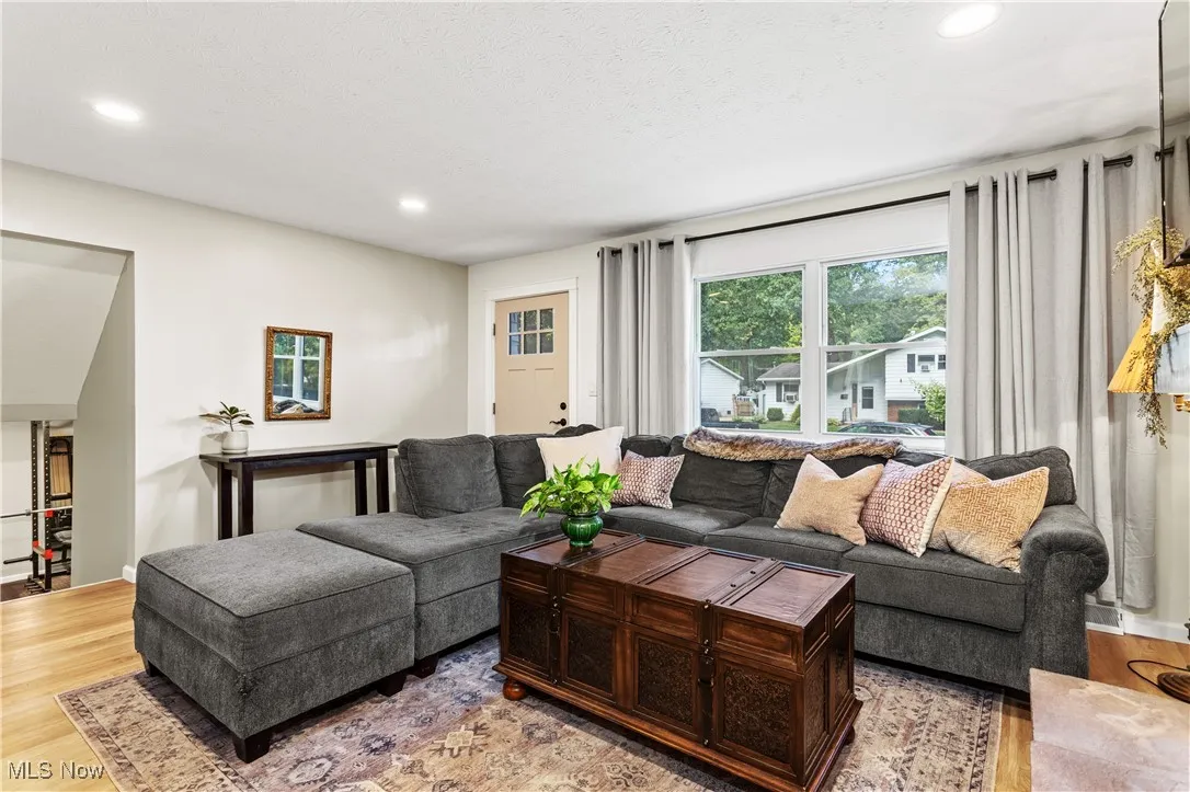 Living area with light wood finished floors, recessed lighting, and healthy amount of natural light