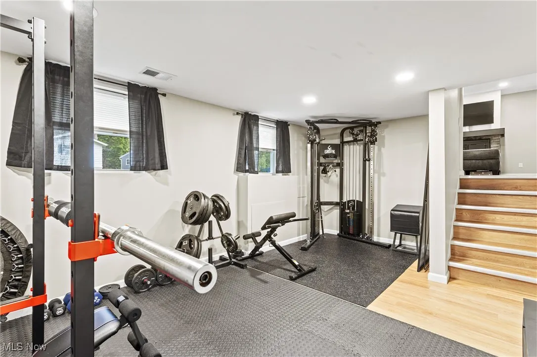 Workout area featuring recessed lighting and light wood finished floors