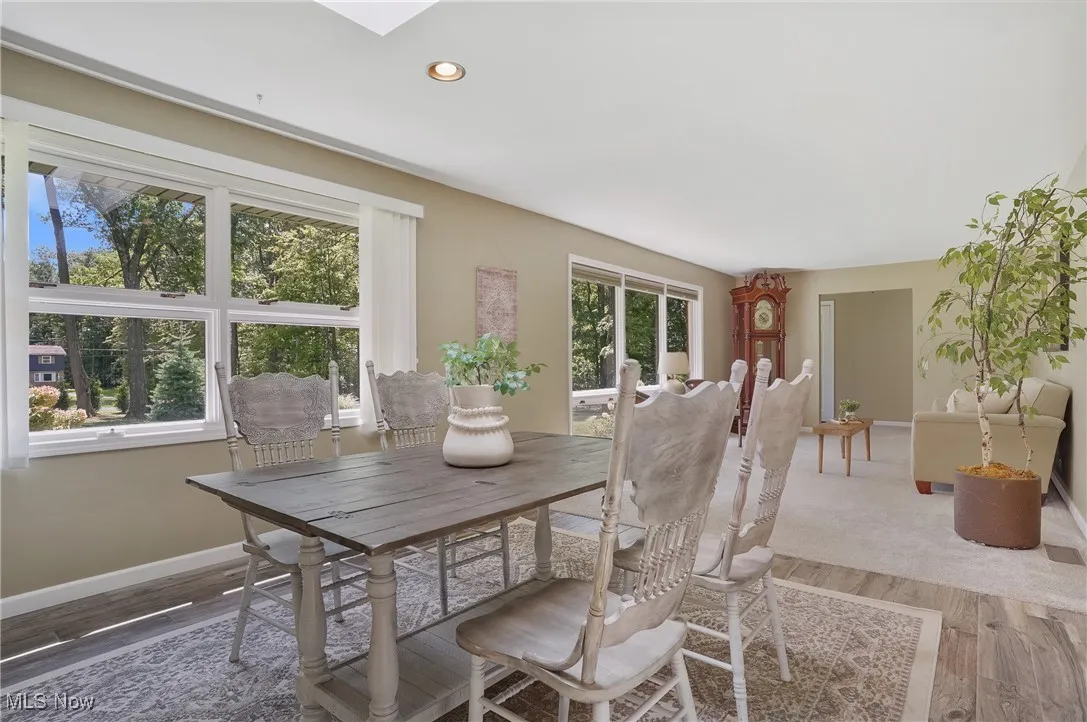 Dining room featuring wood finished floors, recessed lighting, and a skylight