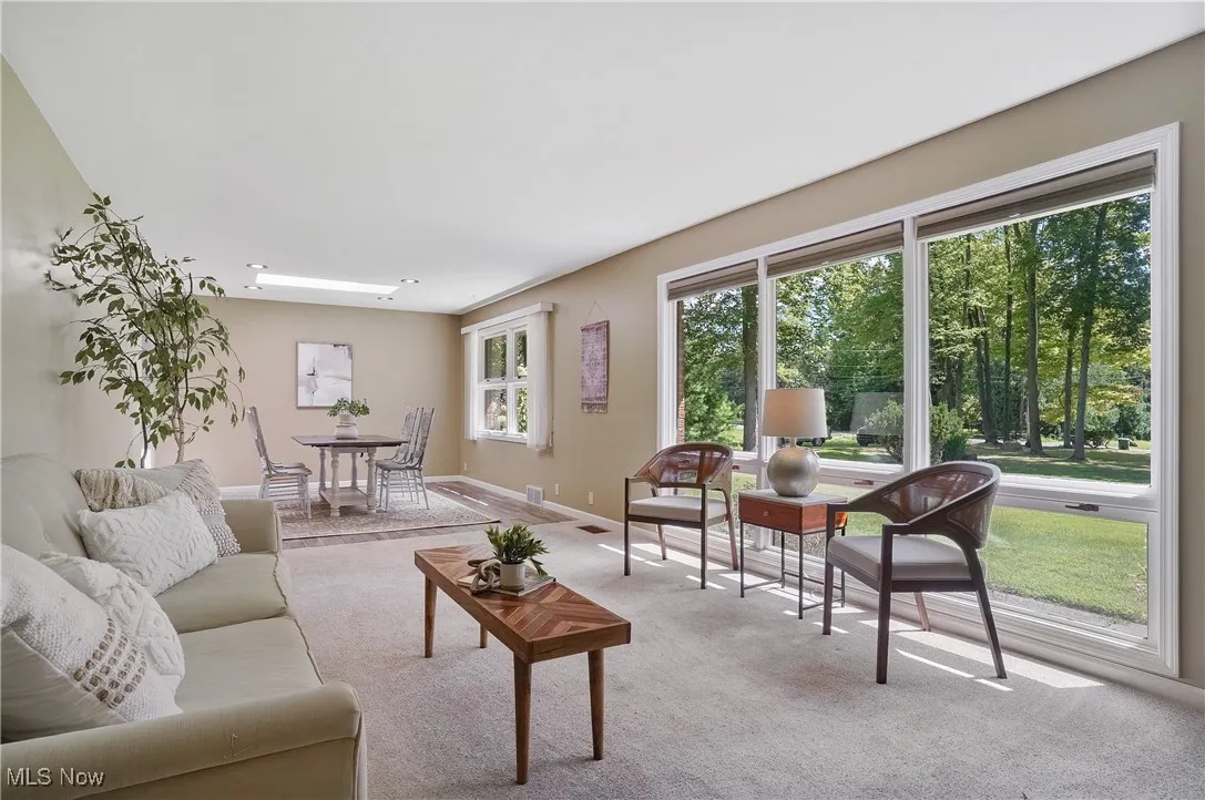 Living room with carpet flooring and baseboards