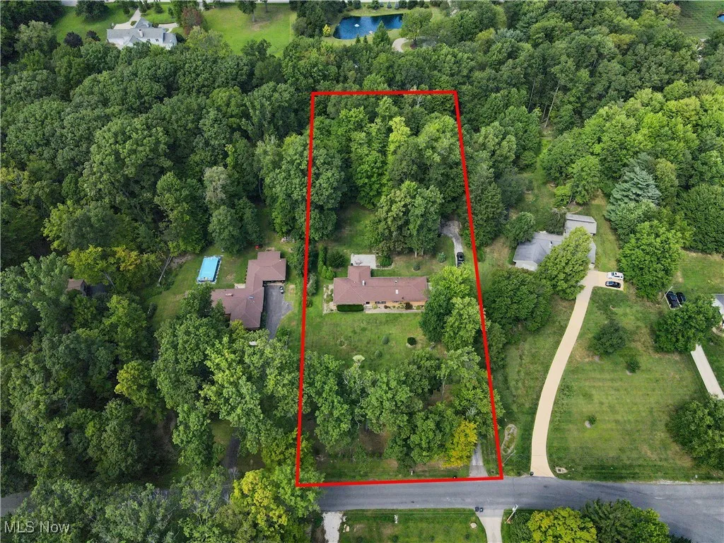 Aerial overview of property's location with a nearby body of water and property parcel outlined