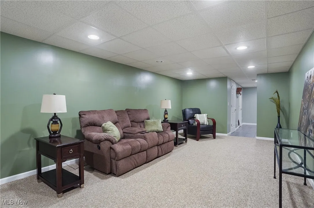 Living room featuring light carpet, recessed lighting, and a paneled ceiling