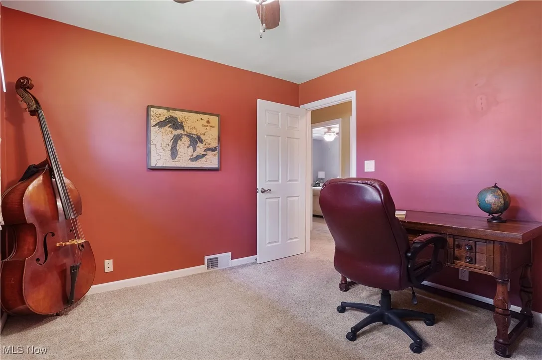 Office area with carpet and a ceiling fan