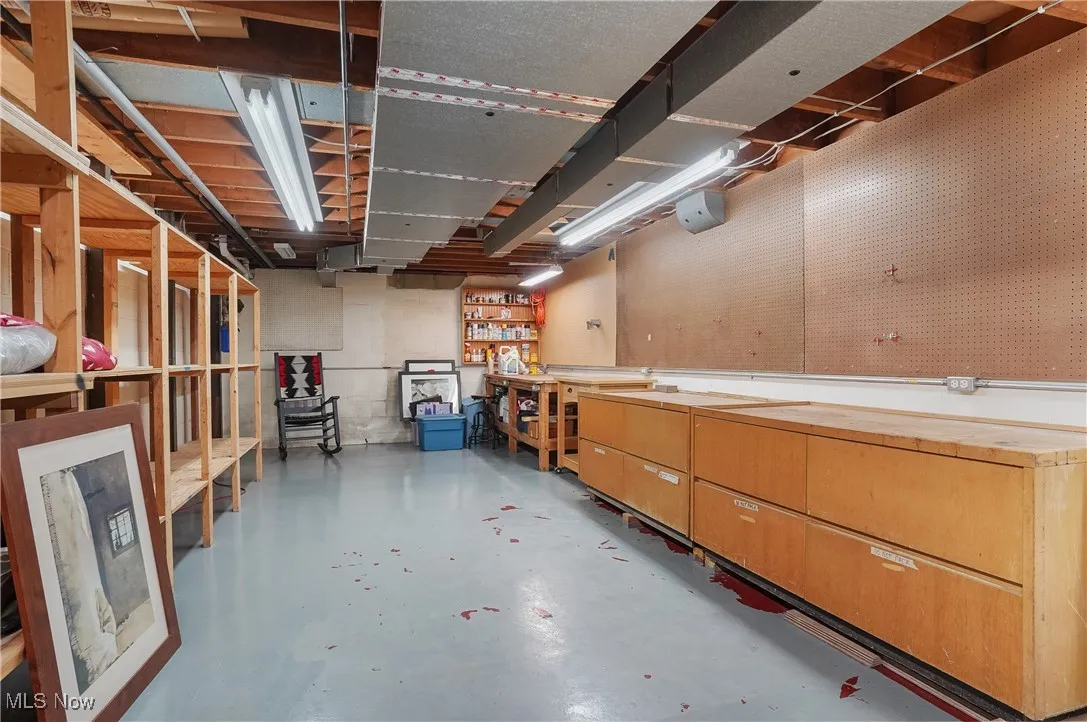 Unfinished basement featuring a workshop area
