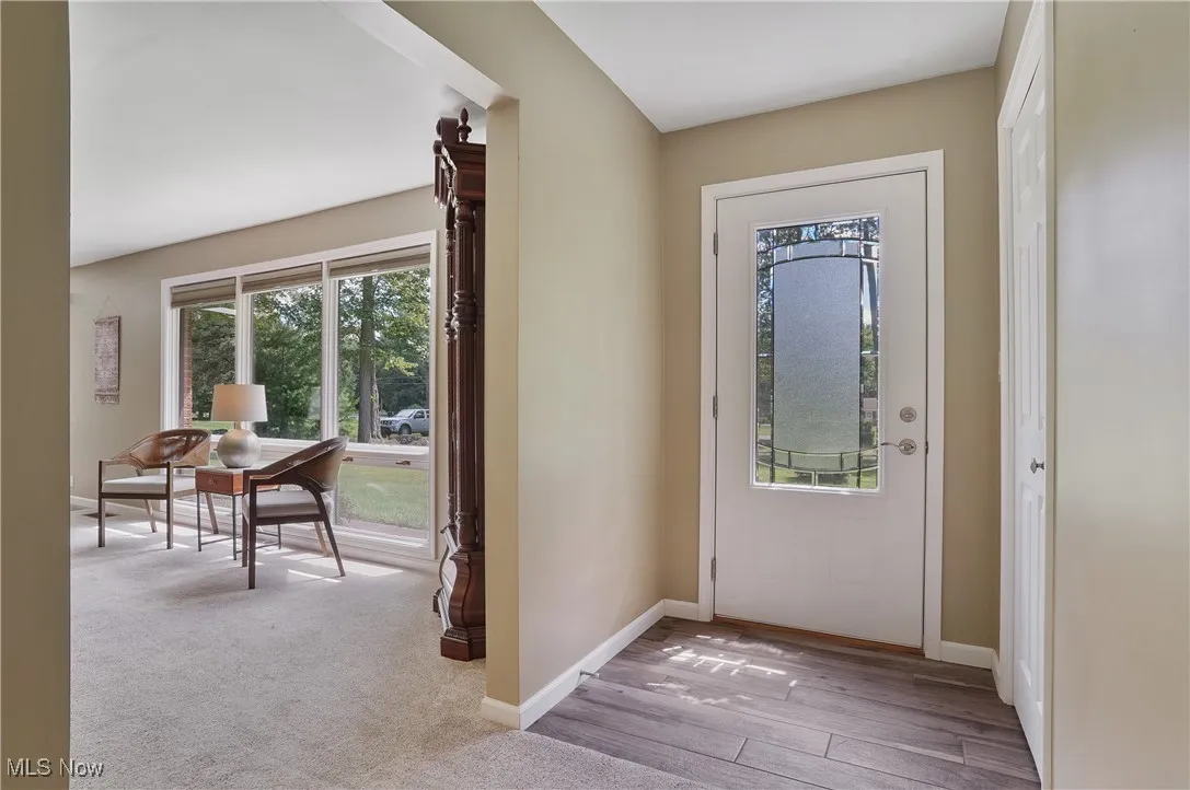 Entrance foyer with baseboards and light wood-style flooring
