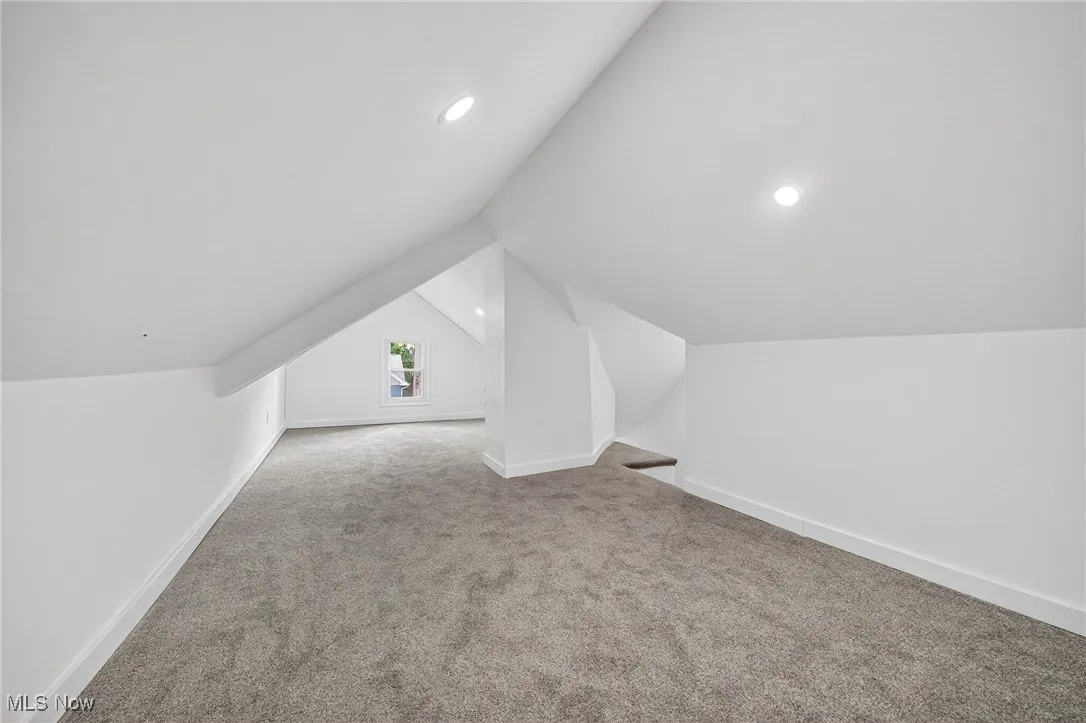 Bonus room featuring light colored carpet, lofted ceiling, and recessed lighting