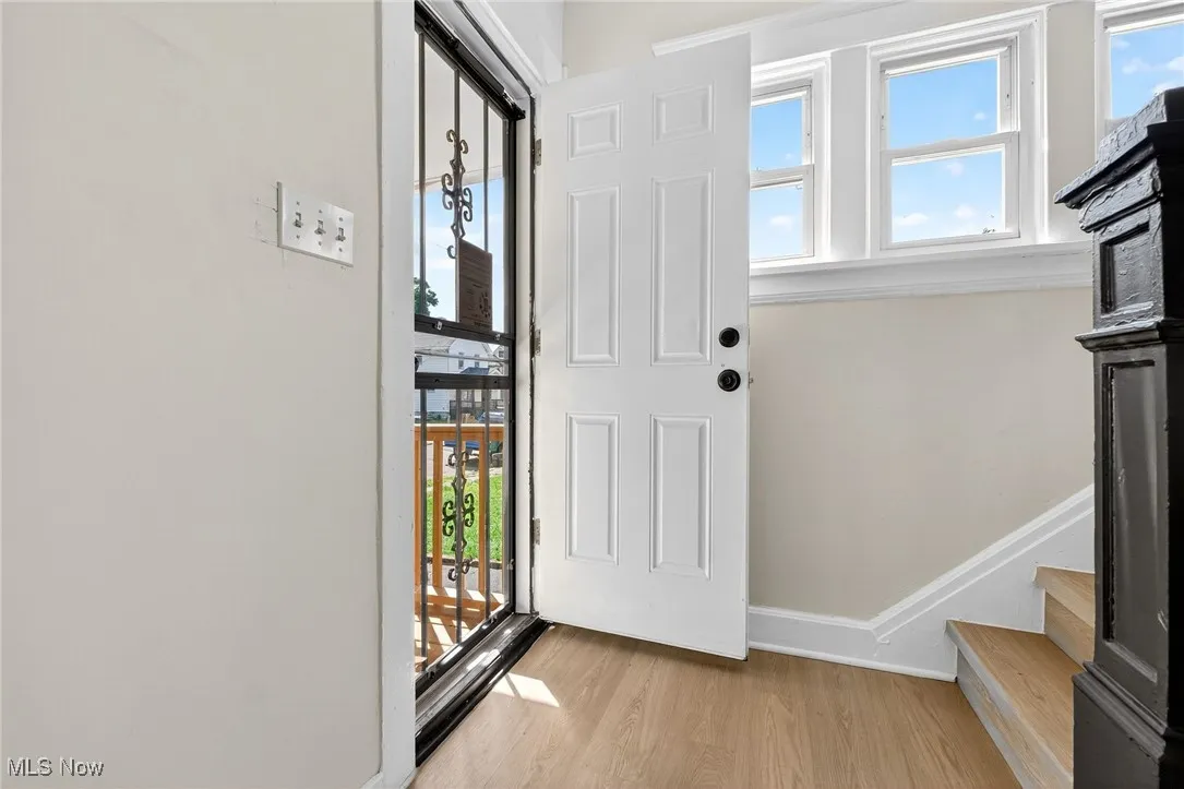 Foyer entrance with wood finished floors and stairs