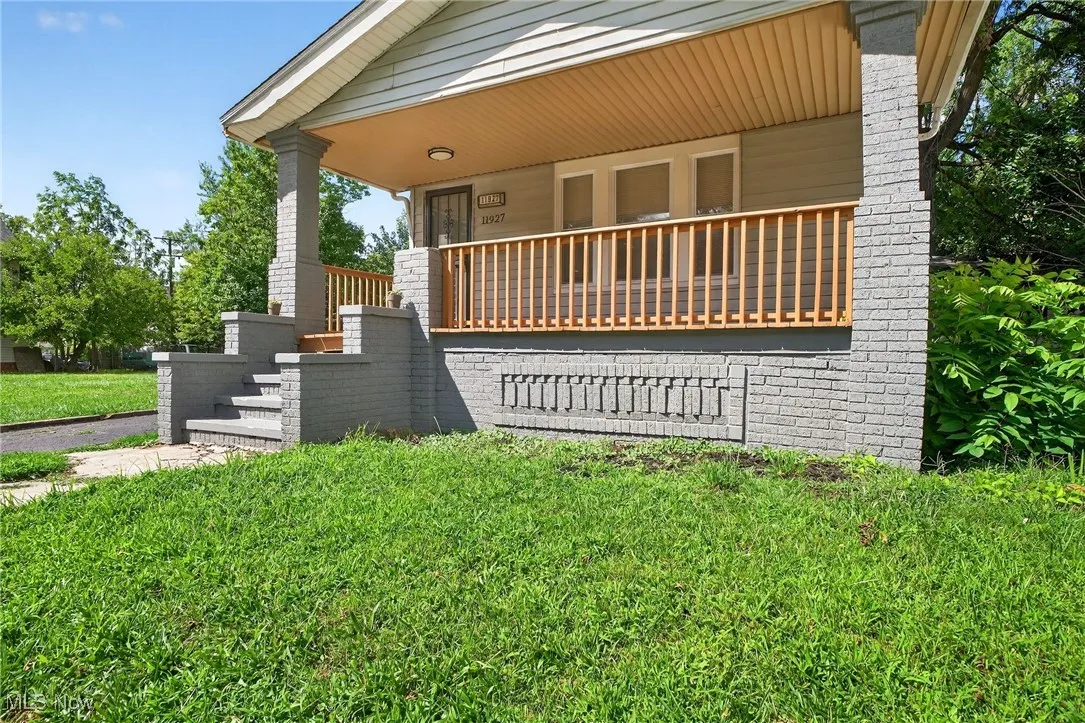 View of front of property with a porch and a front yard