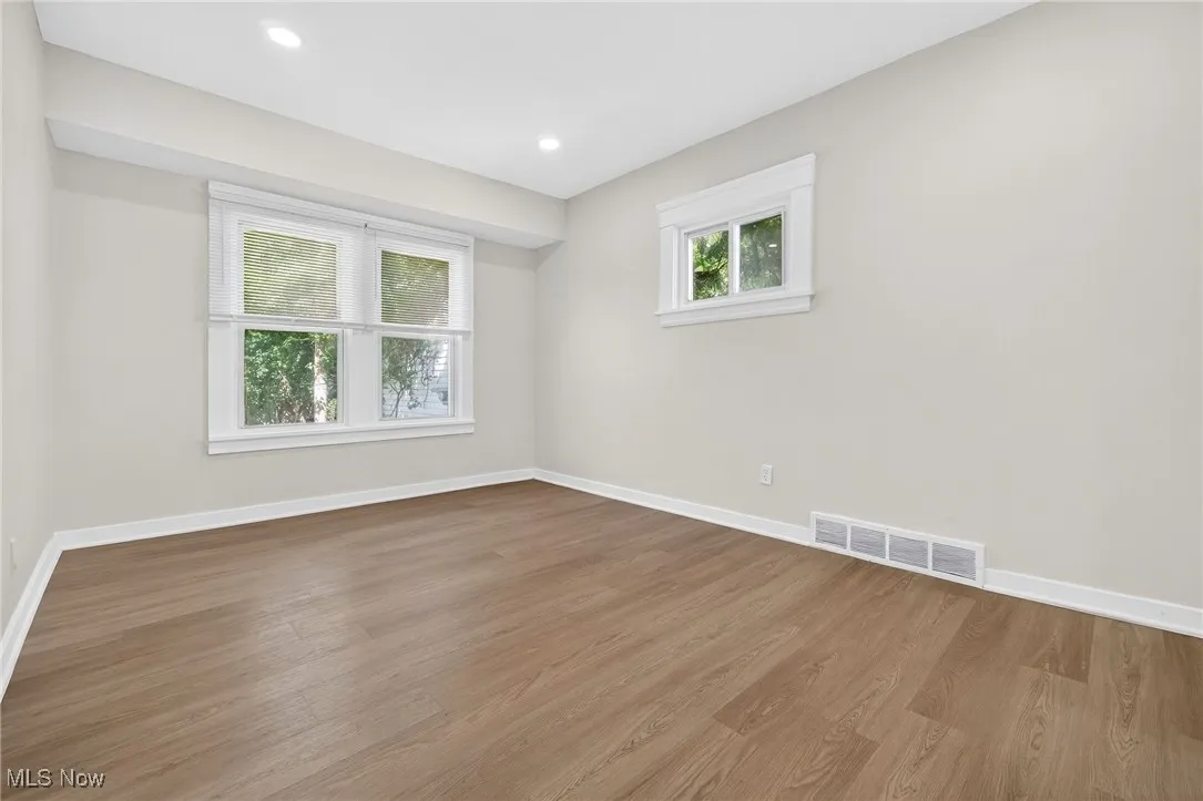 Empty room featuring wood finished floors and recessed lighting