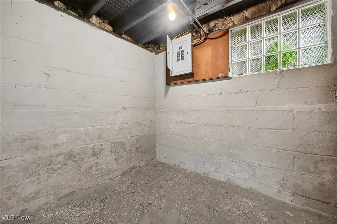Unfinished basement featuring electric panel