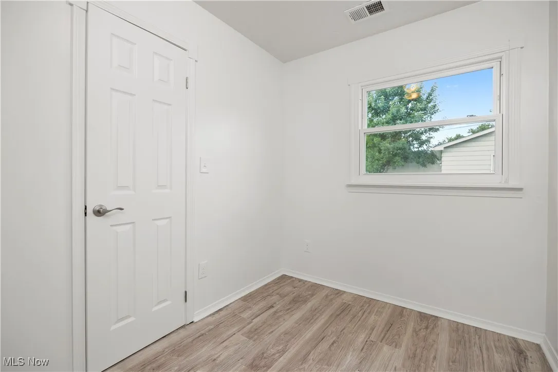 Unfurnished bedroom featuring light wood-style flooring and baseboards