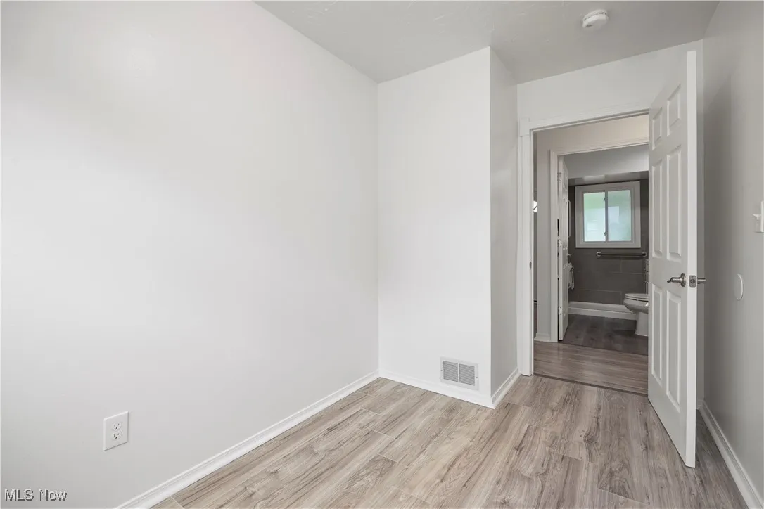 Unfurnished room featuring light wood-type flooring