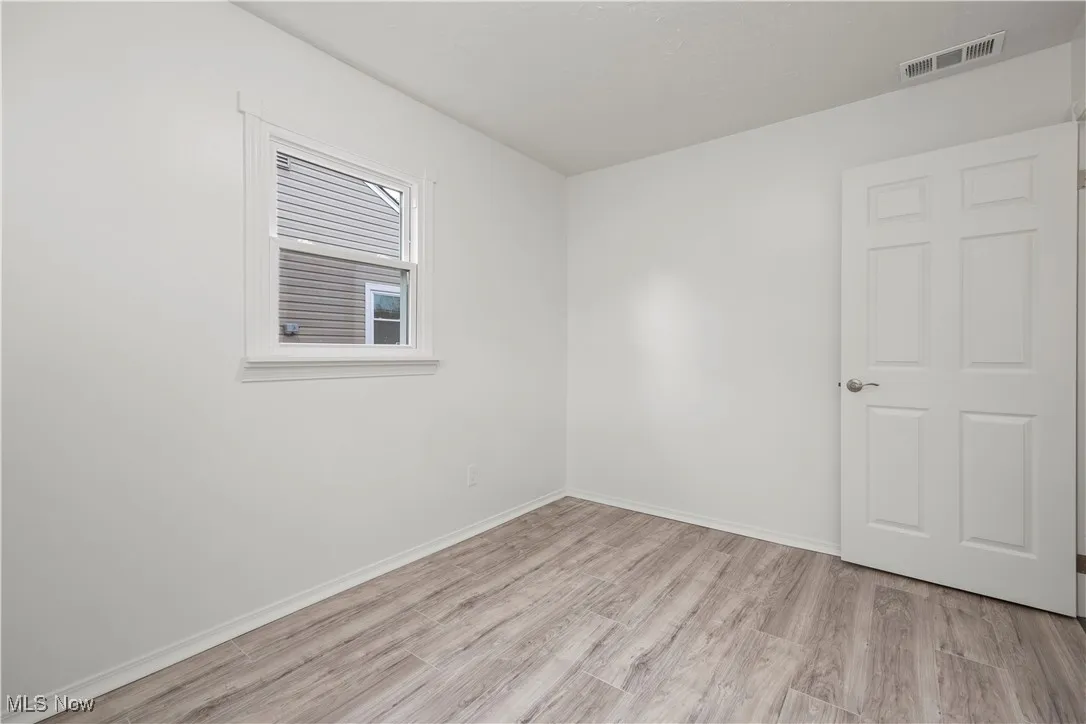 Unfurnished room featuring light wood-style floors and baseboards