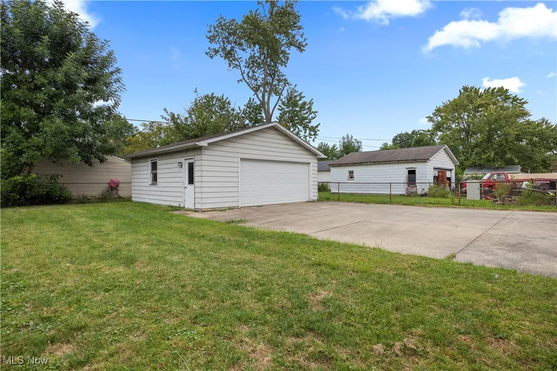 Rear view of house with a patio area and a yard