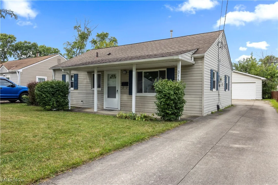 Bungalow featuring roof with shingles, a garage, a front yard, and a porch