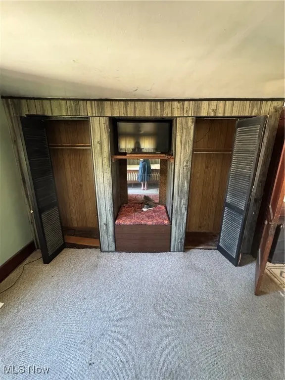 Bedroom featuring light carpet